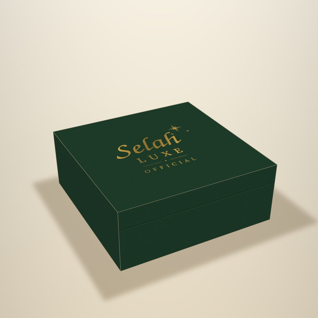 Illustration of a forest green gift box with the gold Selah Luxe Official logo on the lid