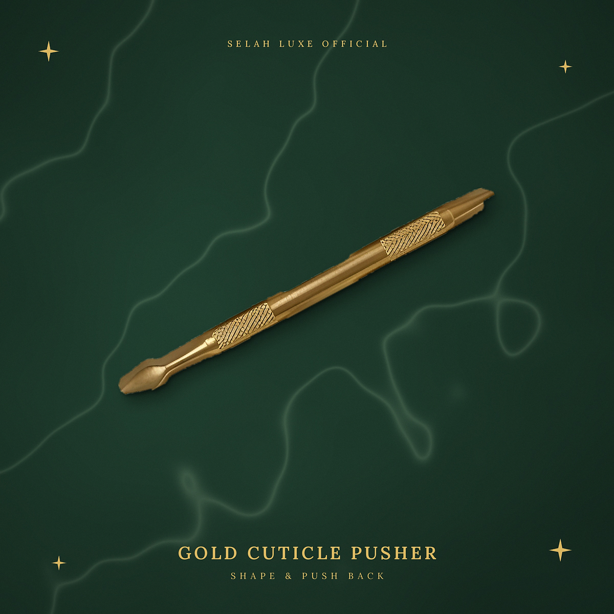 Selah Luxe Official gold cuticle pusher on a cream marble background