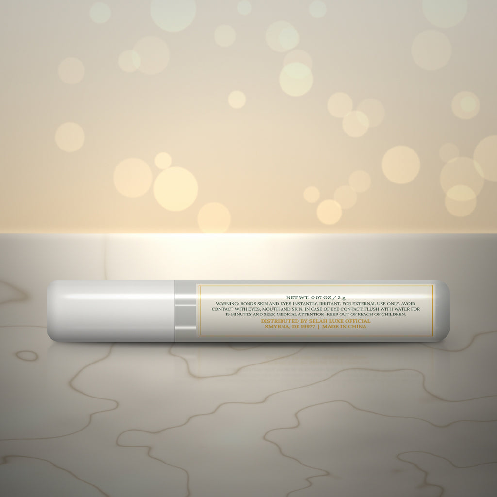 Back of the Selah Luxe Official Mini Pro Glue, 2 g tube, with the warning label