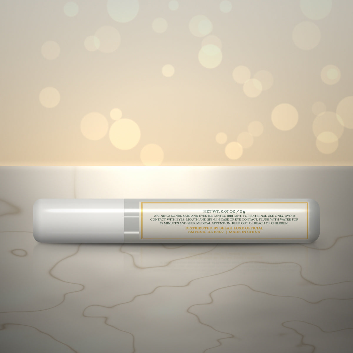 Back of the Selah Luxe Official Mini Pro Glue, 2 g tube, with the warning label
