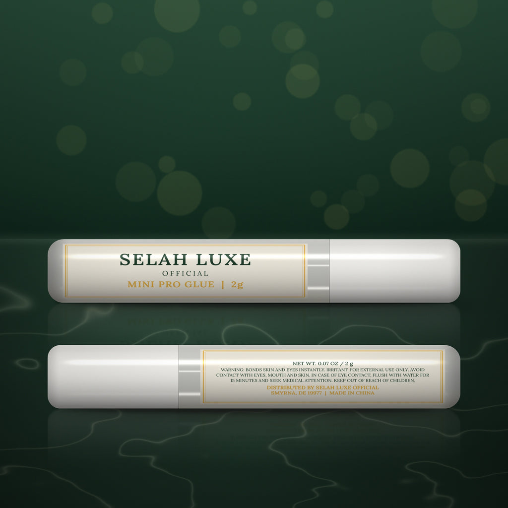 Two tubes of Selah Luxe Official Mini Pro Glue, 2 g, front and back, on a dark green background