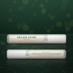 Two tubes of Selah Luxe Official Mini Pro Glue, 2 g, front and back, on a dark green background