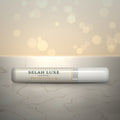 Front of the Selah Luxe Official Mini Pro Glue, 2 g tube, on a cream marble surface